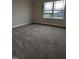 A carpeted bedroom is illuminated by natural light through the window at 1640 Pecan Drive # 44, Nashville, NC 27856
