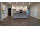 A spacious kitchen with a large island, stainless steel appliances, and wood flooring at 1640 Pecan Drive # 44, Nashville, NC 27856