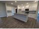 A spacious kitchen with a large island, stainless steel appliances, and wood flooring at 1640 Pecan Drive # 44, Nashville, NC 27856