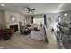 Open living room featuring a fireplace, large windows, ceiling fan, and wood flooring at 1640 Pecan Drive # 44, Nashville, NC 27856