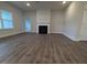 Open living room with black fireplace, large window and an adjoining room at 1640 Pecan Drive # 44, Nashville, NC 27856