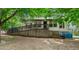 Charming single-story home featuring a ramp for accessibility and surrounded by lush greenery and mature trees at 1701 Sunset St, Roxboro, NC 27573