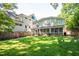 A lush green backyard with a charming screened-in porch and a well-maintained lawn for outdoor enjoyment at 1714 Carson St, Raleigh, NC 27608