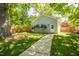 Charming detached garage in a lush backyard setting, complemented by a neatly paved walkway and green lawn at 1714 Carson St, Raleigh, NC 27608