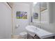 Cozy bathroom with a white vanity, toilet, shower featuring a white curtain, and decorative artwork at 1714 Carson St, Raleigh, NC 27608