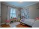 Cozy bedroom featuring hardwood floors, natural light, and a charming dollhouse for added character at 1714 Carson St, Raleigh, NC 27608