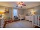 Welcoming bedroom featuring a crib, rug, and a comfortable space for children at 1714 Carson St, Raleigh, NC 27608