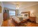 Comfortable bedroom boasts a wooden bed frame, matching nightstands, and a ceiling fan at 1714 Carson St, Raleigh, NC 27608