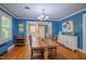 Charming dining room features wood floors, blue walls and connects to the kitchen at 1714 Carson St, Raleigh, NC 27608