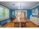 Charming dining room features wood floors, blue walls and connects to the kitchen at 1714 Carson St, Raleigh, NC 27608