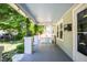 Inviting front porch featuring swing, green accents, and stylish grey flooring at 1714 Carson St, Raleigh, NC 27608