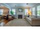 Bright living room featuring a fireplace, hardwood floors, stylish furniture and ample natural light at 1714 Carson St, Raleigh, NC 27608