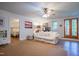 Bright living room with hardwood floors, white sofa, and access to the bedroom and outdoor patio at 1714 Carson St, Raleigh, NC 27608
