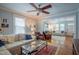 Inviting living room featuring hardwood floors, ceiling fan and large windows at 1714 Carson St, Raleigh, NC 27608
