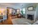 Bright living room featuring a fireplace, hardwood floors, stylish furniture and ample natural light at 1714 Carson St, Raleigh, NC 27608