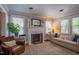 Bright living room featuring a fireplace, hardwood floors, stylish furniture and ample natural light at 1714 Carson St, Raleigh, NC 27608