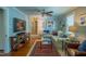 Comfortable living room featuring a hardwood floors, stylish furniture, ceiling fan and ample natural light at 1714 Carson St, Raleigh, NC 27608