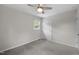 Neutral bedroom featuring carpet floors, a ceiling fan, and closet with an exterior window at 1734 Stage Rd, Durham, NC 27703