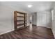 Bedroom featuring wood-look floors, white trim, and a large storage closet at 1734 Stage Rd, Durham, NC 27703