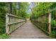 Wooden bridge on a walking path offers a scenic way to enjoy nature within the community at 1734 Stage Rd, Durham, NC 27703