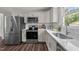 Modern kitchen with stainless steel appliances, white cabinetry, subway tile backsplash, and ample counter space at 1734 Stage Rd, Durham, NC 27703