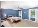 Spacious bedroom featuring a ceiling fan, plush carpet, and large windows for natural light at 180 Long Grass Dr, Smithfield, NC 27577