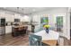 Bright eat-in kitchen featuring stainless appliances, granite counters, and a large window view at 180 Long Grass Dr, Smithfield, NC 27577