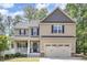 Charming two-story home featuring a covered front porch and attached two car garage at 180 Long Grass Dr, Smithfield, NC 27577