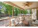 Covered patio with comfortable seating, ceiling fan, and a view of the backyard with a swing set at 180 Long Grass Dr, Smithfield, NC 27577