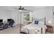 Cozy bedroom with a metal frame bed, ceiling fan, and a dedicated desk area for work or study at 180 Long Grass Dr, Smithfield, NC 27577