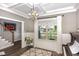 Bright living room showcasing a coffered ceiling, modern lighting, and a view of the front yard at 180 Long Grass Dr, Smithfield, NC 27577