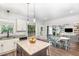 Open-concept kitchen and dining area with hardwood floors and view to the living room at 180 Long Grass Dr, Smithfield, NC 27577
