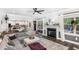 Inviting living space featuring a fireplace, large windows, and an adjacent dining and kitchen area at 180 Long Grass Dr, Smithfield, NC 27577