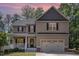 Lovely two-story home featuring a covered front porch beneath a captivating dusk sky at 180 Long Grass Dr, Smithfield, NC 27577