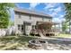 Backyard with a stone fire pit, a deck with a covered patio, and a well-maintained lawn at 180 Long Grass Dr, Smithfield, NC 27577