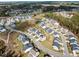 A wide aerial view shows neighborhood layout, homes, tree coverage and neighborhood amenities at 1816 Sandoval Dr, Durham, NC 27703