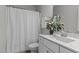 Bright bathroom featuring white vanity with white marble countertop and shower with white curtain at 1816 Sandoval Dr, Durham, NC 27703