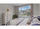 Cozy bedroom with a view of the neighborhood through a large window at 1816 Sandoval Dr, Durham, NC 27703