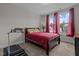 Bedroom features a large window with views of the street, workout equipment and dark wood furniture at 1816 Sandoval Dr, Durham, NC 27703