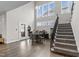 Elegant dining area with tall ceilings, a glass door to the deck, and a stairway to the second floor at 1816 Sandoval Dr, Durham, NC 27703