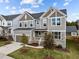 Inviting two-story home with neutral siding, stone accents, a two-car garage, and landscaped front yard at 1816 Sandoval Dr, Durham, NC 27703
