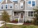 Close-up of a charming home entrance featuring a red front door, stone accents, and well-maintained landscaping at 1816 Sandoval Dr, Durham, NC 27703