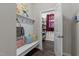 Functional mudroom with storage bench, hooks, decorative pillows, and a pantry with shelving at 1816 Sandoval Dr, Durham, NC 27703