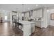 Modern kitchen featuring an island with bar seating, gray cabinets, stainless steel appliances, and hardwood floors at 1816 Sandoval Dr, Durham, NC 27703
