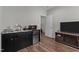 Kitchenette featuring black cabinets with stainless sink, microwave, refrigerator and nearby TV at 1816 Sandoval Dr, Durham, NC 27703