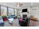 Bright living room with a fireplace, large windows, ceiling fan and comfortable seating at 1816 Sandoval Dr, Durham, NC 27703