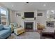Open-concept living room featuring a fireplace, plush seating, and views of the staircase at 1816 Sandoval Dr, Durham, NC 27703