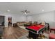 Spacious recreation room featuring a pool table, seating area, and hardwood floors at 1816 Sandoval Dr, Durham, NC 27703