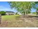 Backyard view with mature trees providing shade and privacy to the expansive lawn and recreational areas at 182 Jesse Dr, Smithfield, NC 27577