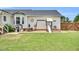 Charming backyard featuring a play area, picnic table, and a spacious lawn for Gathering fun at 182 Jesse Dr, Smithfield, NC 27577